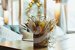 Stalks of dry wheat in vase on blurred background. Wheat spikelets. Image for design and interioir.Straws or dry plants photo