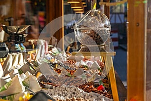 Stall with burnt almonds and other sweets at a traditional Christmas market, selected focus