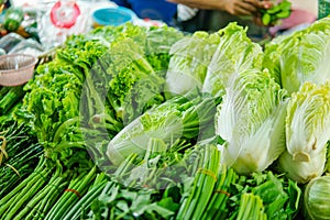 A stall in a market selling assorted vegetables including