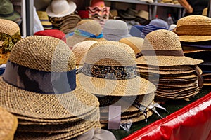 a stall selling straw hats in a market place