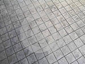 Stamp concrete black color hardener printing patterns on the cement or mortar surface block shape Square pattern material rough