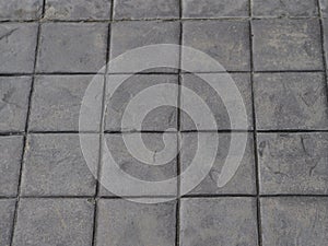 Stamp concrete black color hardener printing patterns on the cement or mortar surface block shape Square pattern material rough