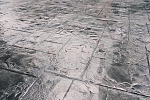 Stamp concrete texture pattern and background, and reflection of sunlight on the floor.