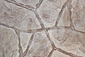 Stamped concrete mosaic patterns, earth tone colors and textures from directly above.
