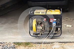 Stand-alone diesel generator to supply electricity in an emergency. Yellow color. Serves not a large residential building