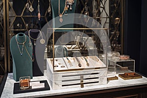 a stand-alone jewelry display with a mix of delicate and bold pieces