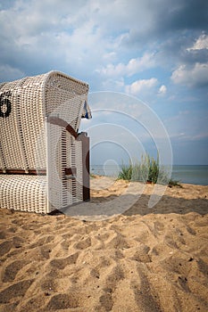 at the stand of the Baltic Sea there is a white beach chair