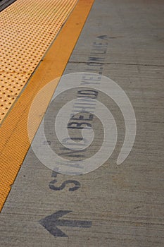 Stand behind yellow line