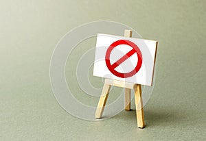 Stand with a canvas and a red prohibition sign NO. Inability to sell products, ban on the import. Restriction on the importation photo