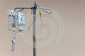 A stand with a dropper and therapeutic solutions prepared for intravenous infusion of drugs. Place for text