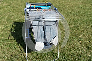 Stand with garments hanging for dry up after washing