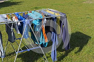 stand with garments hanging for dry up after washing