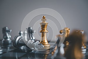 stand of golden king chess and fallen silver king chess.chess board game concept of business ideas and competition and stratagy