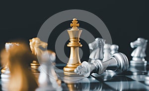 stand of golden king chess and fallen silver king chess.chess board game concept of business ideas and competition and stratagy