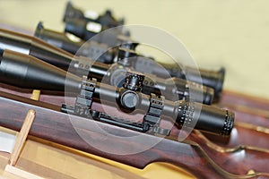 Stand with hunting rifles with telescopic sights