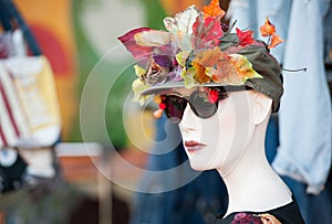 Stand with mannequin in vintage floral hat