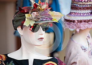 Stand with mannequin in vintage floral hat
