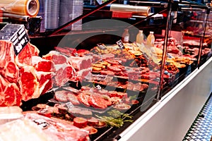 Stand with raw meat in supermarket store