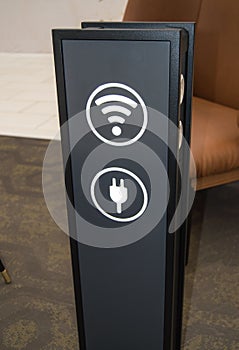 Stand tower for charging mobile phones in a shopping center, the sign of a wifi zone, a vertical image, background rest