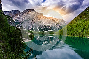 Stand up paddle board on Lake Braies (also known as Pragser Wildsee or Lago di Braies) in Dolomites Mountains, Sudtirol, Italy.