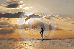 Stand Up Paddle Boarding In Japan During a sunrise and sunset after a typhoon