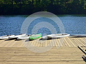 Stand-up Paddleboards on a Dock on the Lake