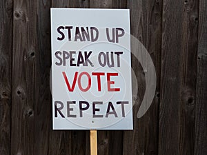 Stand up speak out vote repeat sign