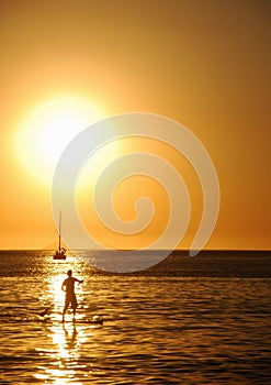 Stand-up on sunset on Itaipu Beach photo