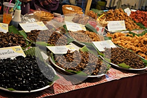 A stand of edible insects in a market, Thailand