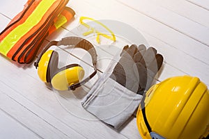 Standard construction safety equipment on wooden table