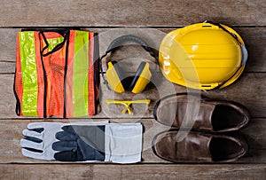 Standard construction safety equipment on wooden table. top view