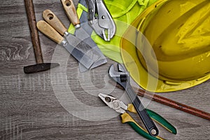 Standard construction safety equipment on wooden table. top view