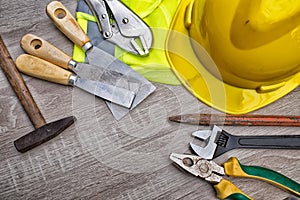 Standard construction safety equipment on wooden table. top view