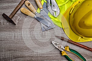 Standard construction safety equipment on wooden table. top view