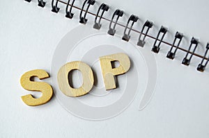 Standard Operating Procedures wooden text on white notepad.