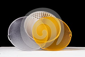 Standard reflector with matt white and yellow diffuser on a black background. Different diffusers for light temperatures.