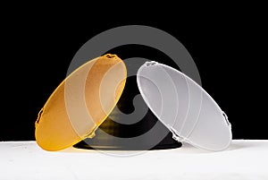 Standard reflector with matt white and yellow diffuser on a black background. Different diffusers for light temperatures.