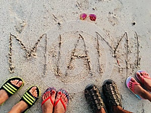 Standing on beach  sand  sandals writing on sand