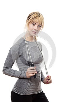 Standing blonde woman with a skipping rope