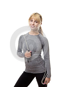 Standing blonde woman with a skipping rope