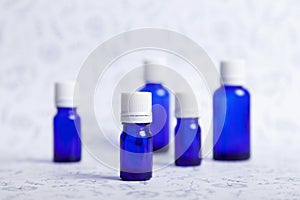 Standing blue vials on a patterned backgorund