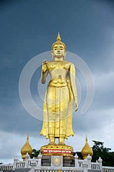 Standing Buddha image.The attitude of persuading the relatives not to quarrel symbol of Golden Buddha statue  at Kho Hong Hill photo