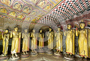 Standing Buddha statues inside Cave Three (Maha Alut Viharaya) at the Dambulla Cave Temples in central Sri Lanka.