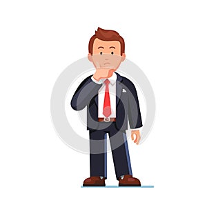 Standing business man making thinking gesture