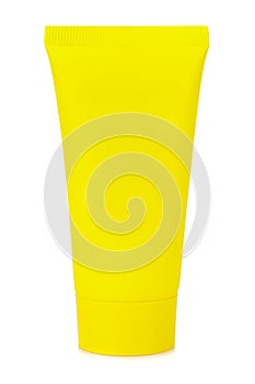 Standing on cap blank yellow plastic tube for cosmetics cream isolated on white background