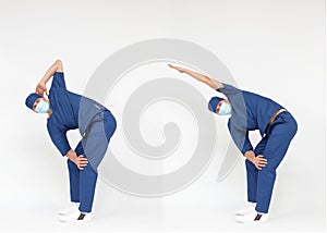 Standing caucasian medical professional  in uniform  stretching back and arms