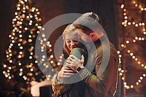 Standing and embracing each other. Young lovely couple have romantic dinner indoors together