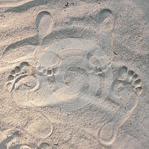 Standing footsteps ou a couple in  the sand