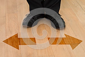 Standing in front of left or right arrows on floor