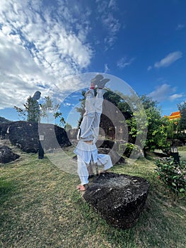 Standing with head on a solid rock